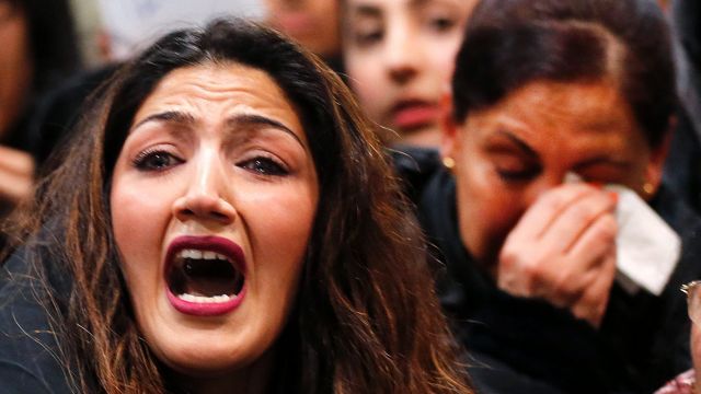 A demonstrator shouts during a protest against the deportation of Afghan asylum seekers at the airport in Frankfurt, ...