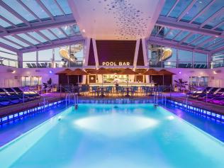 Royal Caribbean introduces its newest and most technologically advanced cruise ship Anthem of the Seas. Pool Bar at sunset