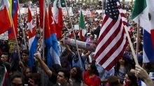 Demonstrators hold signs and flags during a protest against US President-elect Donald Trump outside of the Federal ...