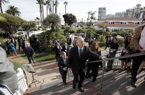 California Gov. Jerry Brown, center, arrives for a news conference ahead of Canadian Ambassador David MacNaughton, behind, during the Western Governors Association winter meeting at the Hotel del Coronado Tuesday, Dec. 13, 2016, in Coronado, Calif.