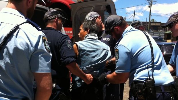 Van Ngo is escorted into a police vehicle in St Peters. He was arrested a second time and charged after he returned to ...