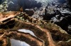 A cave explorer stands on rimstone formations in Hang Son Doong, Vietnam.