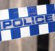 Blue and white Police tape cordoning off broken fence area at a residential house like a crime scene, Australia 2016