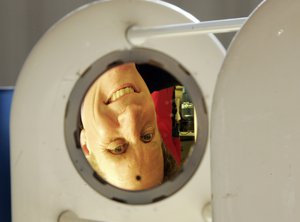 The inverted image of project scientist Paul A. Newman of NASA's Goddard Space Flight Center is seen in the copper-colored mirror of a laser hygrometer, used to measure water vapor, that will be carried aboard a Global Hawk, a version of the Air Force's top-of-the-line unmanned spyplane, which will be used by NASA for scientific research, at its unveiing at Edwards Air Force Base, Calif., Thursday, Jan. 15, 2009.