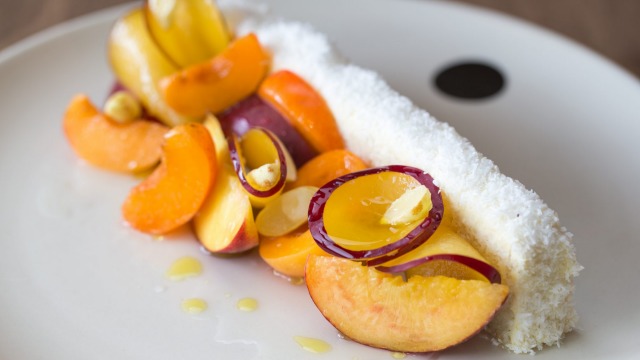 Flavours of summer: Coconut vanilla cake with stone fruit and almonds.