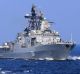 A Chinese Navy frigate and a Russian Navy ship take part in a joint naval drill in the South China Sea.