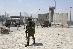 Israeli army soldiers patrol the parameter of the Qalandia checkpoint, a main crossing point between Jerusalem and the West Bank city of Ramallah, Wednesday, April 27, 2016.