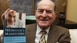 FILE - In this Feb. 5, 2014, file photo, Dr. Henry Heimlich holds his memoir prior to being interviewed at his home in ...