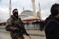 A member of the security forces stands guard during funeral prayers for police officer Tugay Can Kizilirmak, 26, who was ...