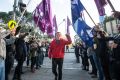 Roz Ward gives a clenched fist salute after returning to work at La Trobe University following controversy earlier this year.