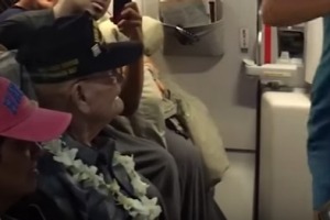 Ray Richmond, 97, a veteran of Pearl Harbour was honoured by the Makaha Sons who performed a song, while an air-hostess ...