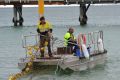 Council workers installing a similar beach enclosure at the Busselton foreshore.