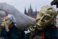 A man in a mask depicting Milos Zeman marches during commemorations for the anniversary of the Velvet Revolution.