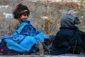 Evacuated children sitting on the ground in western rural Aleppo.