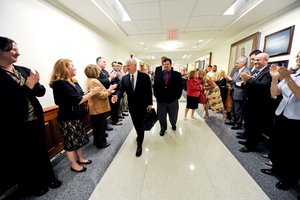 File - Defense Secretary Robert M. Gates shakes hands with Defense Department employees as he departs the Pentagon for a final time as secretary, June 30, 2011.