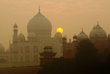 The sun rises over the Taj Mahal in Agra, India.