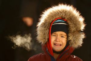 Theo Bradeen, 5, of reacts to the cold as he disembarks from a ferry after a ride from his home on Peaks Island to ...