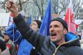 People shout slogans as anti-government protesters gather in front of the Constitutional Court in Warsaw, Poland.