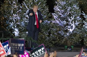 President-elect Donald Trump points into the audience after a rally in Orlando, Fla., Friday, Dec. 16, 2016.