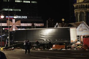 Police officers stand beside a truck which ran into a crowded Christmas market and killed several people in Berlin, Germany