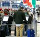 Travelers use self service kiosks to print out boarding passes at O'Hare International Airport in Chicago, Illinois, ...