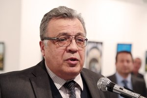 The Russian Ambassador to Turkey Andrei Karlov speaks at a gallery in Ankara Monday Dec. 19, 2016.