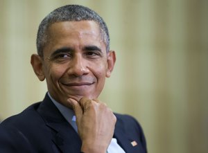 President Barack Obama smiles as he listens to Irish Prime Minister Enda Kenny speak during their meeting in the Oval Office of the White House in Washington, Tuesday, March 15, 2016.