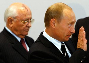 Russian President Vladimir Putin, right, and former Soviet leader Mikhail Gorbachev arrives at the German-Russian Petersburg Dialogue conference in Dresden on Tuesday, Oct. 10, 2006.