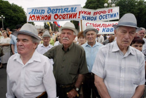 People hold posters reading "Peace for South Ossetian children!", "Hands off South Ossetia!" as they attend a rally in central Vladikavkaz, 30 June 2007.