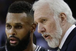 San Antonio Spurs coach Gregg Popovich speaks with Patty Mills.