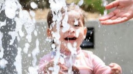 Anika, 2, plays in a water feature in Sydney. 
