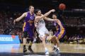 Passing manoeuvre: United's Chris Goulding executes a quick release under pressure from Kings defence.