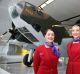 Virgin Australia staff with the Australian War Memorial's Lockheed Hudson bomber now on display at Canberra Airport.