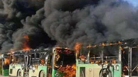 Smoke rises from green government buses awaiting to evacuate residents in Idlib province, Syria on Sunday.