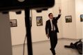 A man with a gun shouts inside the Ankara gallery as Russian ambassador to Turkey Andrei Karlov lies on the ground.