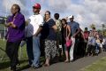 Native Fijians and ethnic Indians in a queue to vote in Fiji.