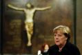 German Chancellor Angela Merkel arrives to sign the condolence book at the Kaiser Wilhelm Memorial Church in Berlin.