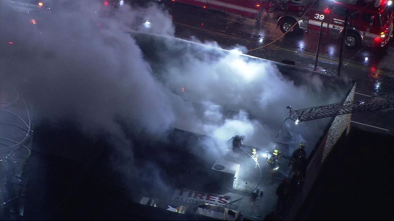 Los Angeles firefighters are seen extinguishing a brief yet explosive fire in a building in Van Nuys on Wednesday, Dec. 21, 2016.