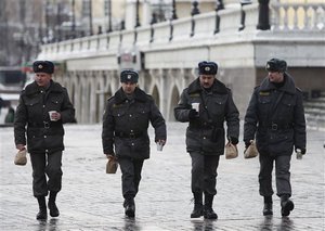 Russia Airport Blast - Police officers walk across Manezh Square in downtown Moscow, Tuesday, Jan. 25, 2011, during a lunch break.