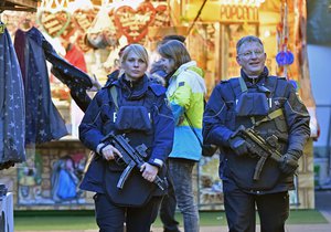 Police officers patrol at the Christmas market in Dortmund, Germany, Tuesday Dec. 20, 2016.