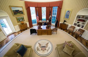 President Barack Obama makes Thanksgiving Day phone calls from the Oval Office to U.S. troops stationed around the world, Nov. 24, 2016.