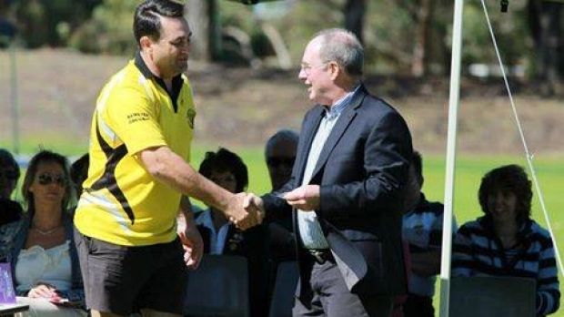 Bradley Edwards shaking hands with former WA Labor leader Eric Ripper during a presentation for his 10 years' service at ...