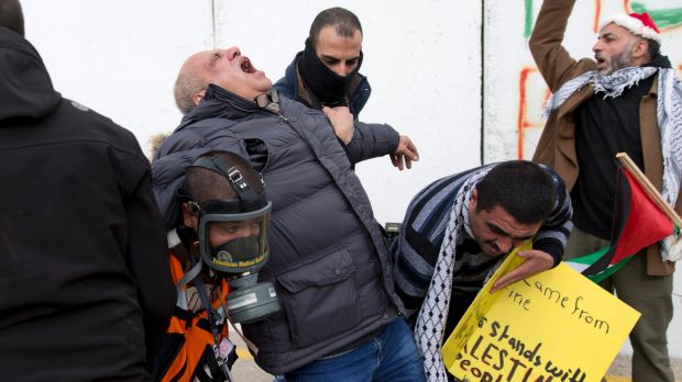 AP cameraman Eyad Hamad is evacuated after being hit by tear gas during clashes between Palestinian protesters and ...