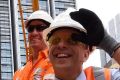 Andrew Constance (right) witnessing the first track being cemented in place.