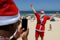 Natalie Williams from Britain celebrates Christmas at Bondi Beach.