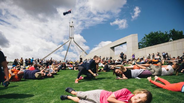 Hundreds roll down the slope of the Parliament House lawns