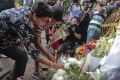 Members of an Indian family lay flowers at the scene of a deadly attack by militants at a bakery in Dhaka in July. 