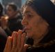 A woman prays during Christmas Eve Mass in Bartella, Iraq.