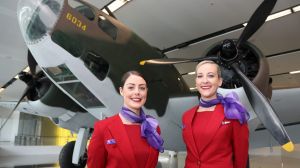 Virgin Australia staff with the Australian War Memorial's Lockheed Hudson bomber now on display at Canberra Airport.