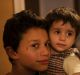 Members of a Syrian refugee family who arrived seven months ago prepare a meal for another family about to arrive to ...